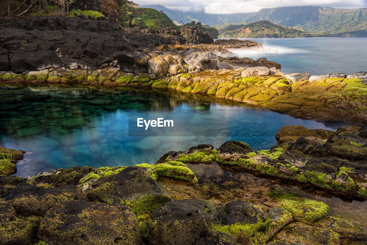 Long exposure of the calm waters of queen's bath, a rock pool off princeville on north kauai