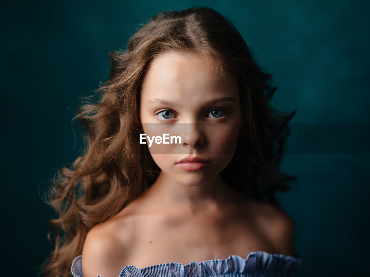 Portrait of girl against green background