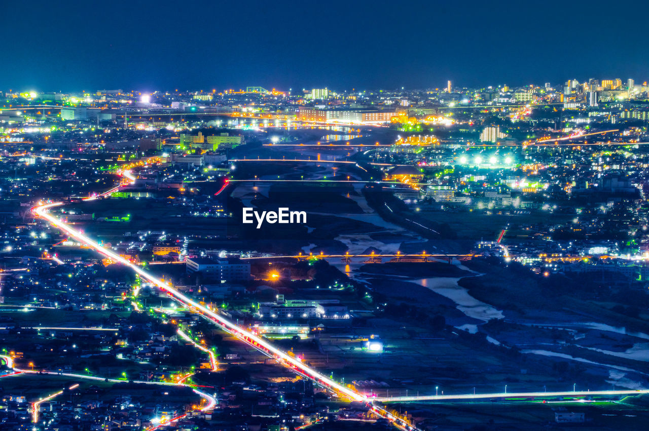 High angle view of illuminated city buildings at night