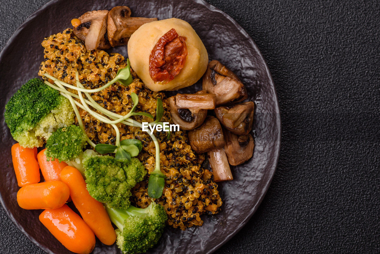 food, food and drink, healthy eating, vegetable, freshness, wellbeing, meal, dish, studio shot, broccoli, produce, indoors, no people, green, meat, cuisine, high angle view, fruit, plate, herb, spice, still life, carrot, root vegetable, directly above, fried, black background, fast food