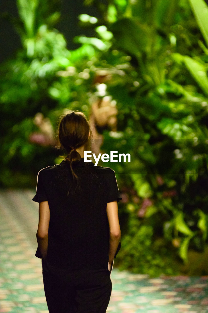 Rear view of woman walking in park