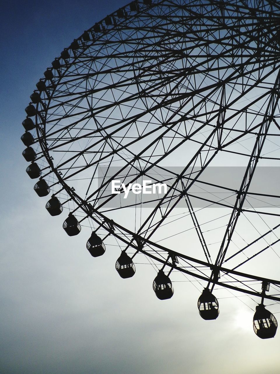 Low angle view of ferris wheel against sky