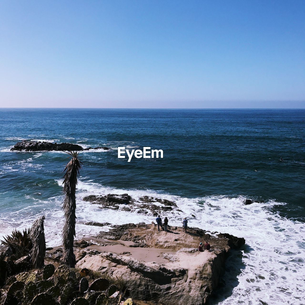 Scenic view of seascape against clear blue sky