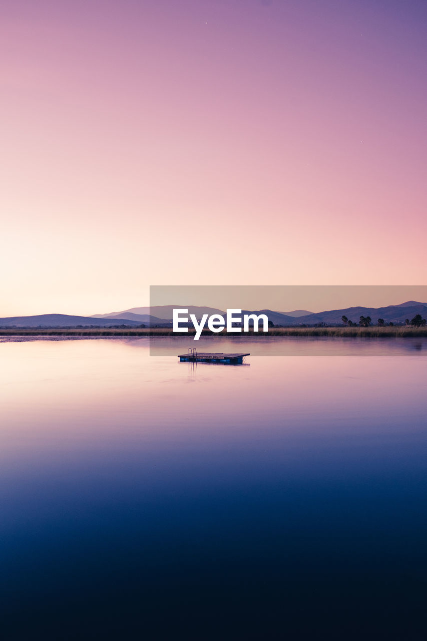 Scenic view of sea against clear sky during sunset