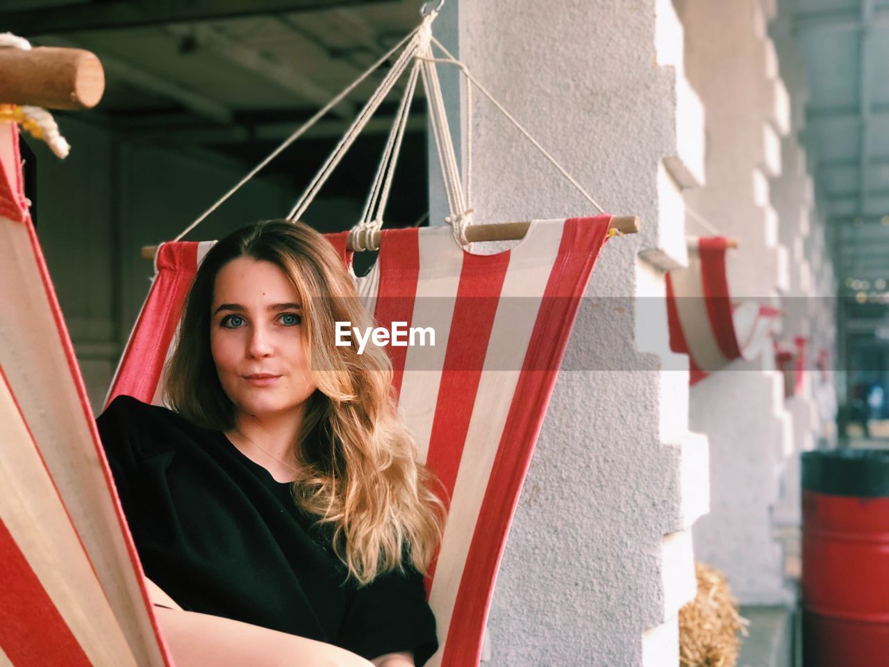 Portrait of smiling young woman relaxing in hammock