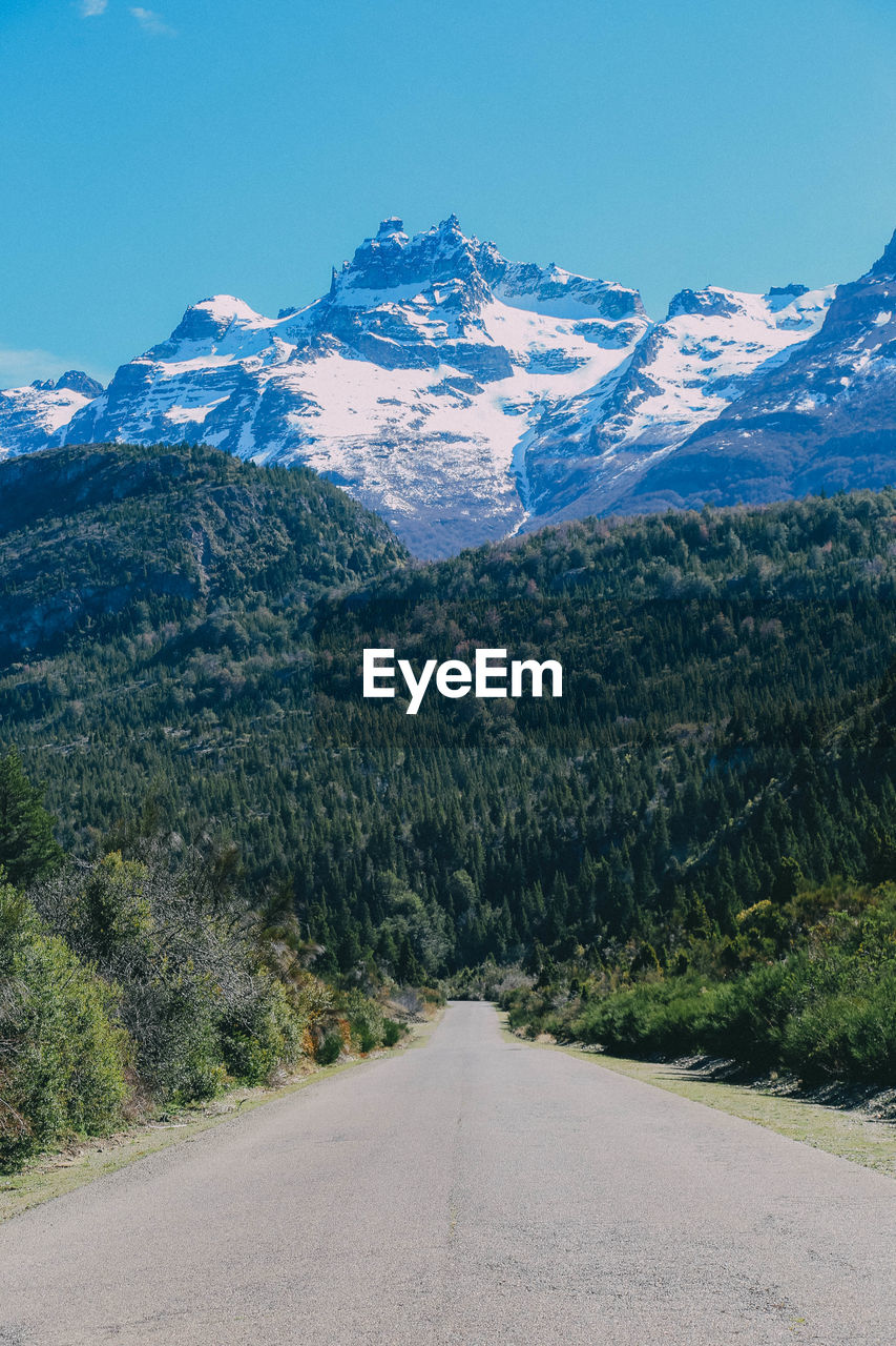 Scenic view of snowcapped mountain against clear blue sky