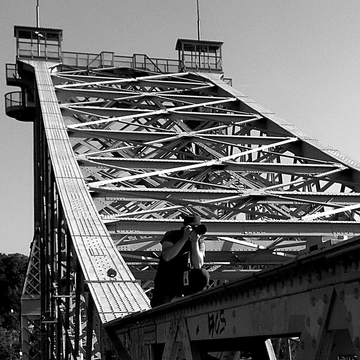 Man photographing on bridge