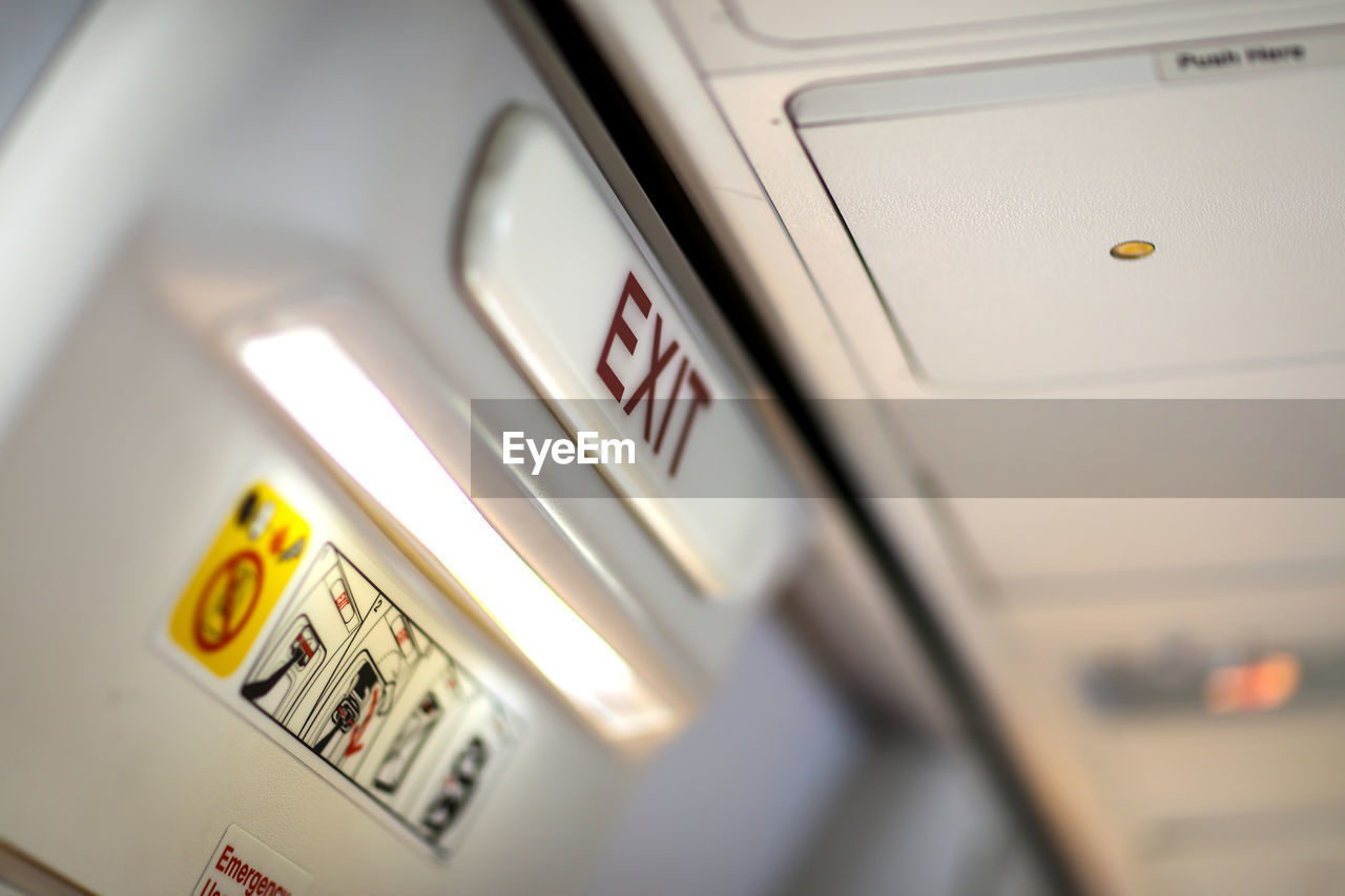 Close-up of exit sign in airplane