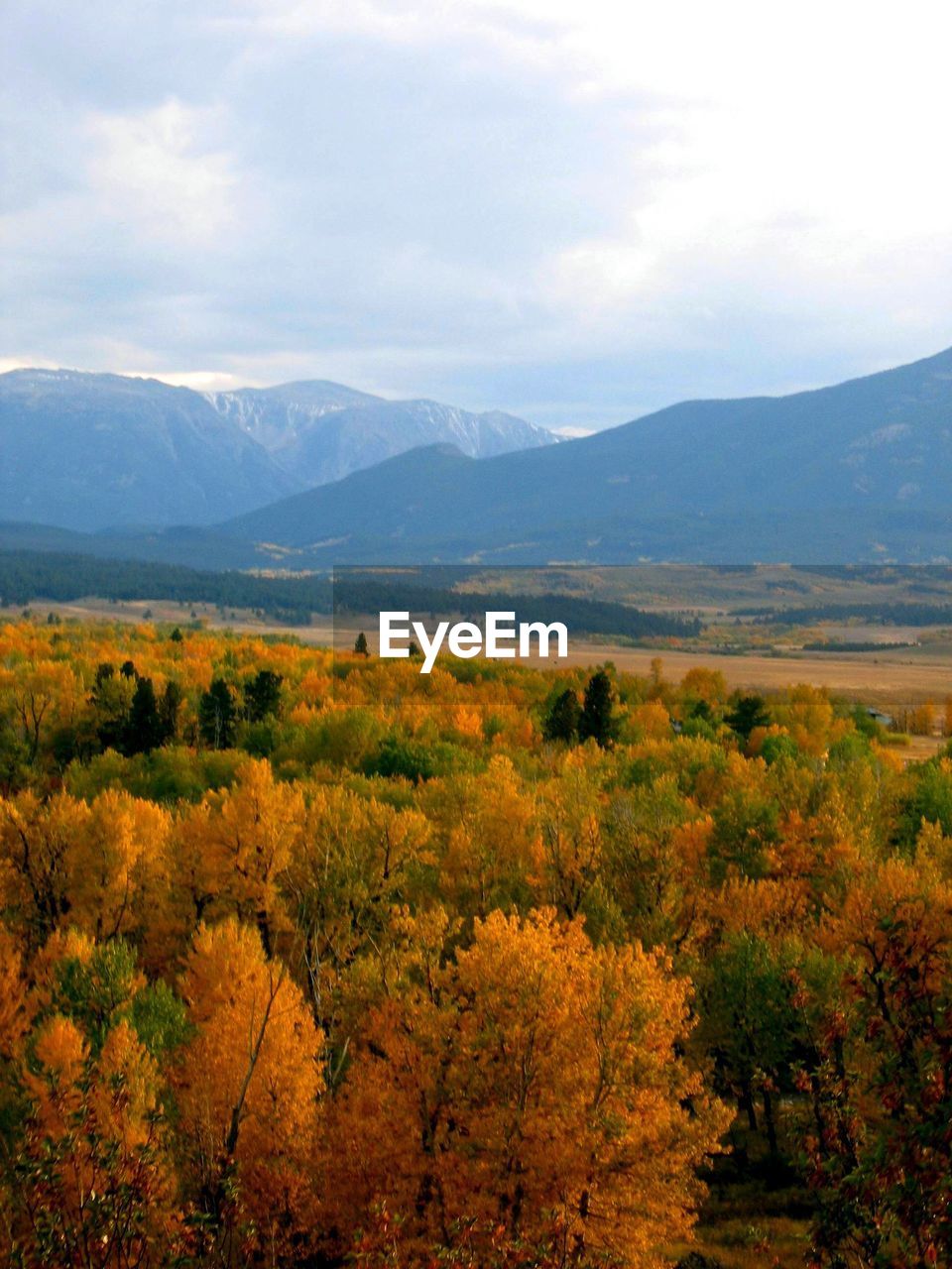 Scenic view of mountains against cloudy sky