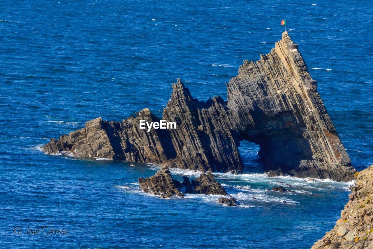 Scenic view of sea against rocks