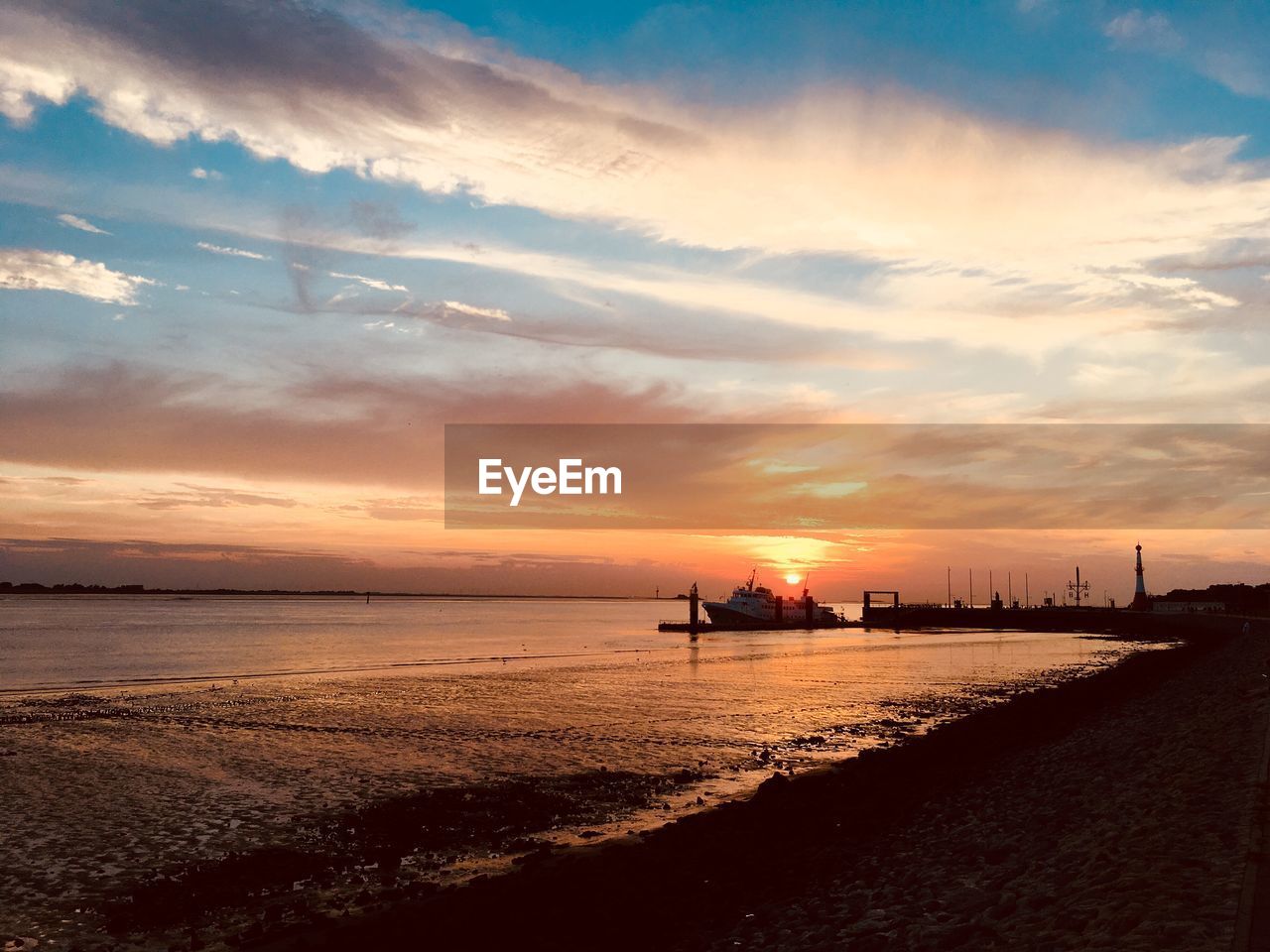 SCENIC VIEW OF BEACH DURING SUNSET