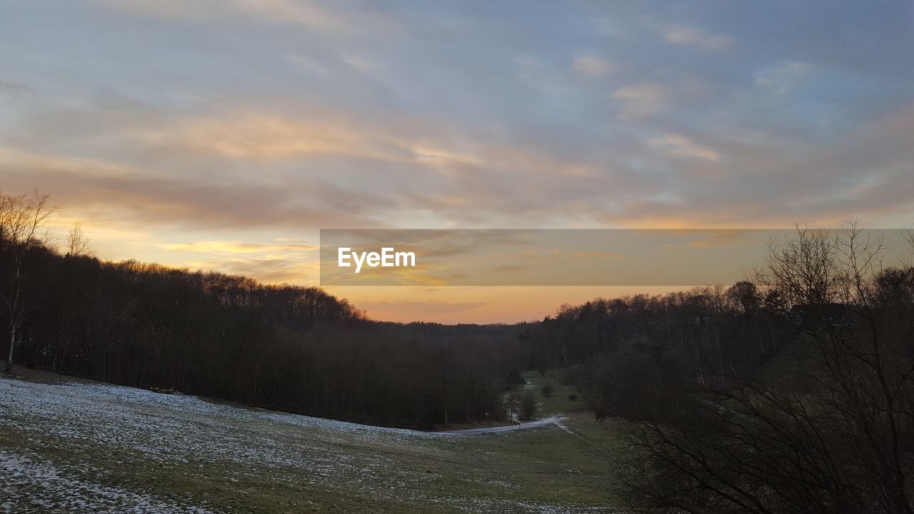 SCENIC VIEW OF LAND DURING SUNSET