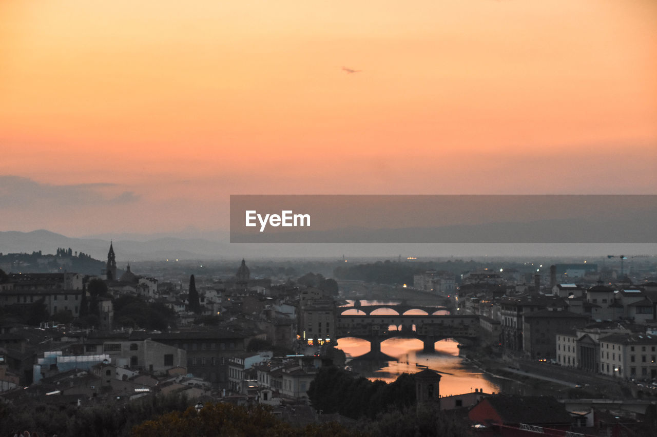 HIGH ANGLE VIEW OF BUILDINGS AT SUNSET