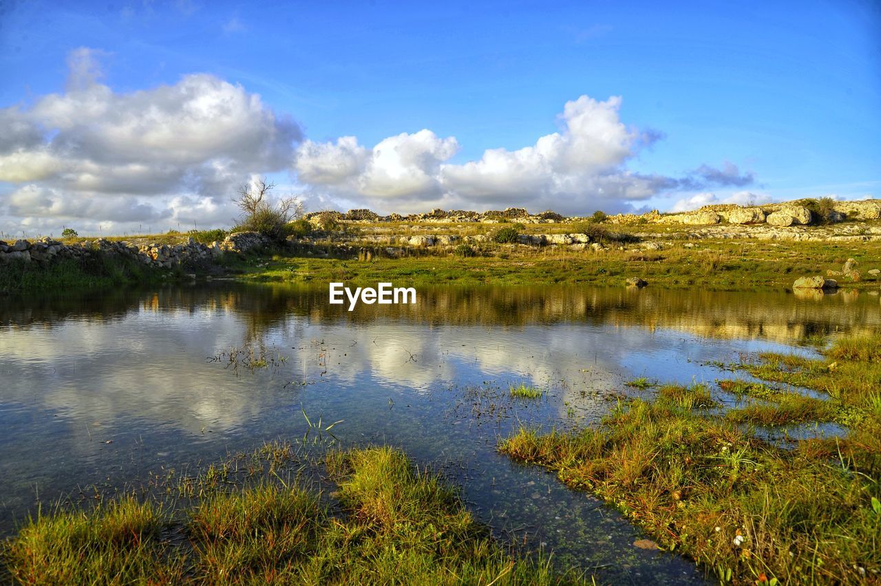 reflection, nature, water, sky, natural environment, wilderness, landscape, plant, environment, scenics - nature, beauty in nature, cloud, grass, lake, meadow, wetland, morning, no people, land, tranquility, marsh, tree, tranquil scene, blue, travel destinations, grassland, non-urban scene, autumn, horizon, travel, day, outdoors, rural area, bog, prairie, mountain, green, forest, tourism, leaf