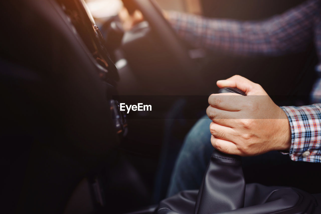 The driver holds the gear in the showroom.