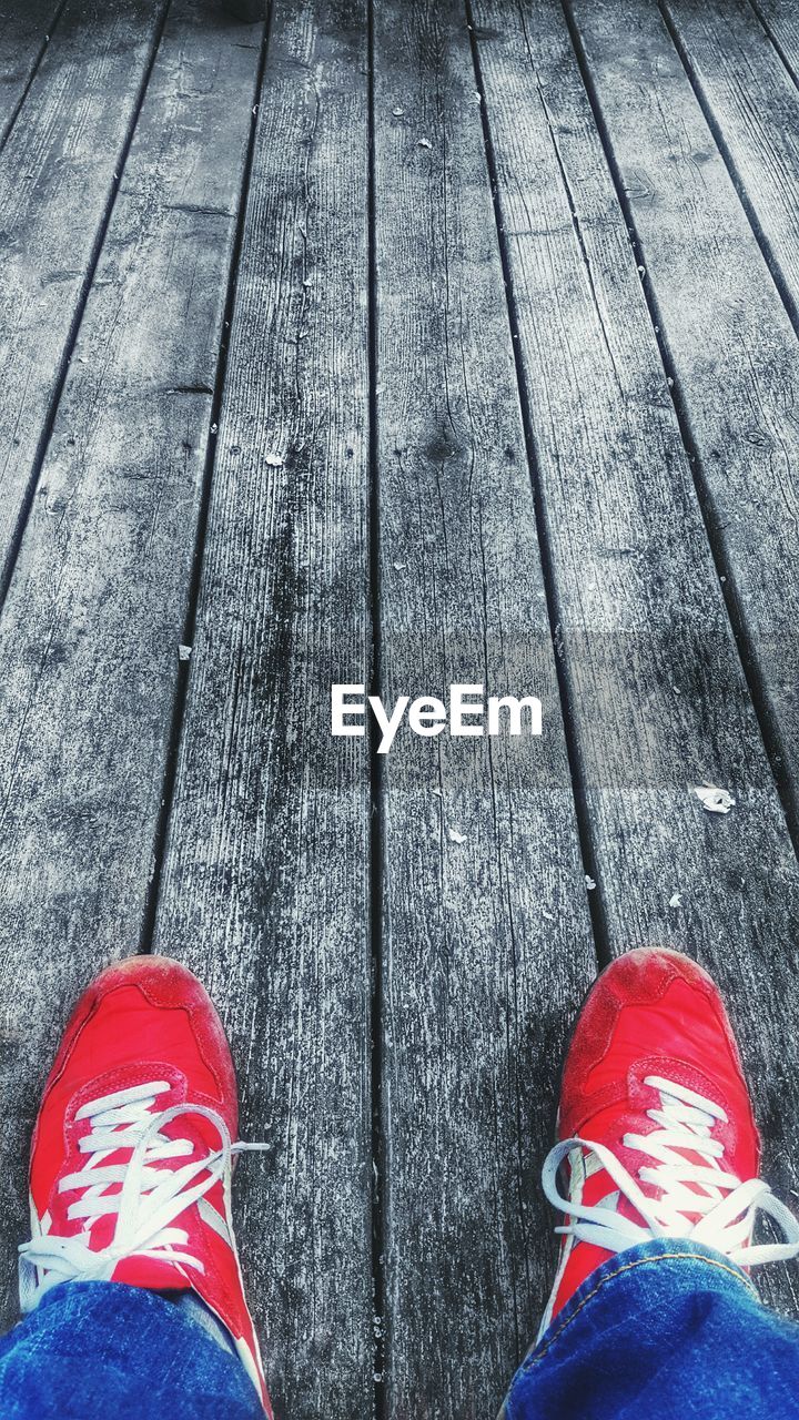 Low section of man on boardwalk