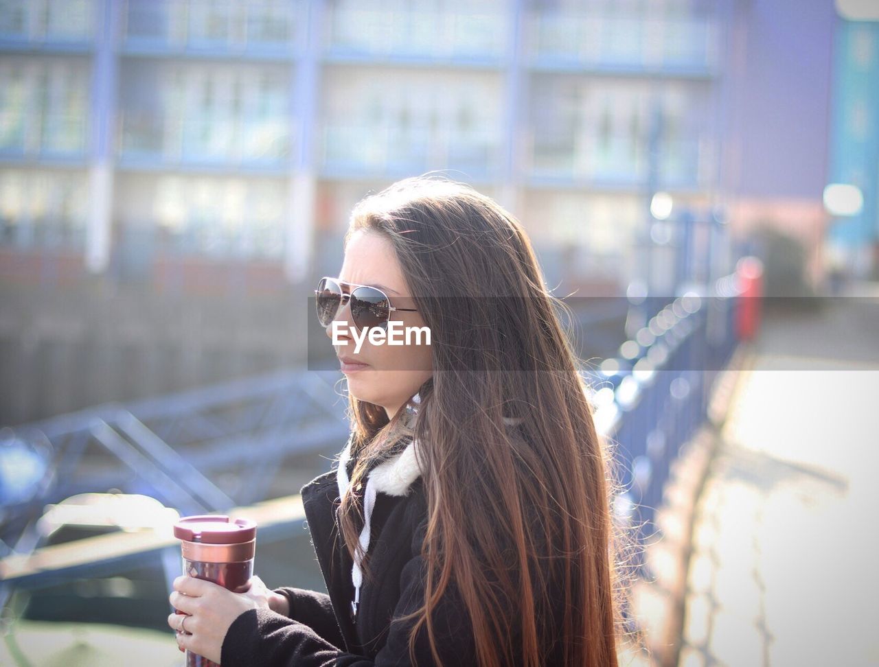 Young woman drinking coffee outdoors