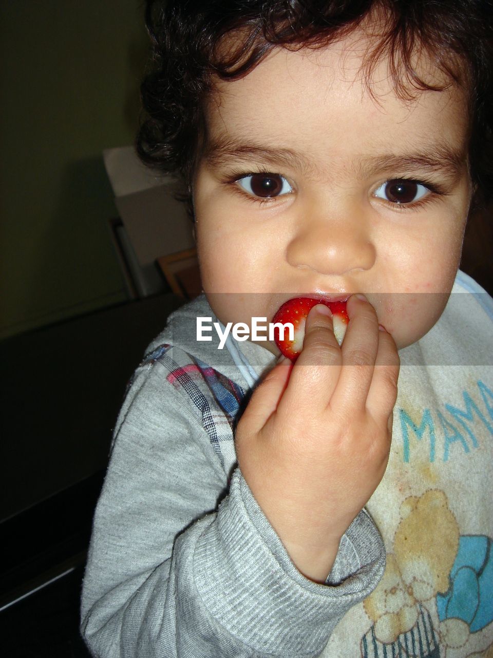 CLOSE-UP PORTRAIT OF GIRL EATING BABY