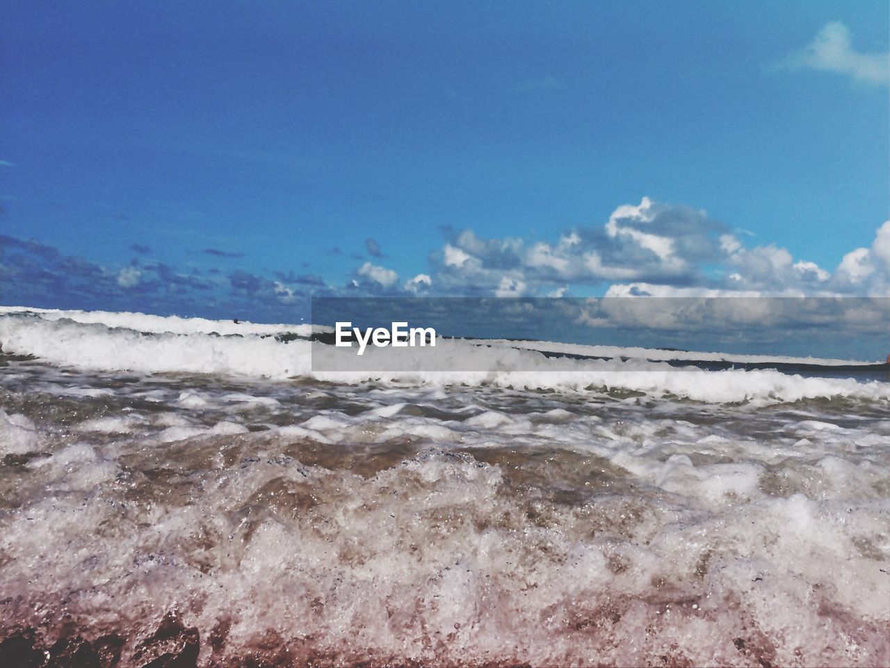 VIEW OF BEACH AGAINST BLUE SKY