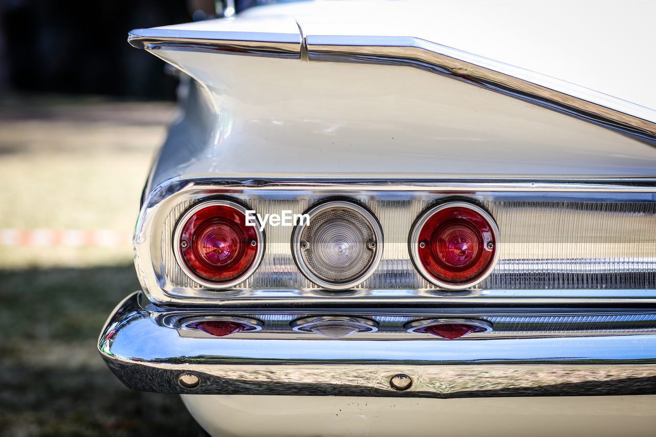 Close-up of taillight of vintage car during sunny day