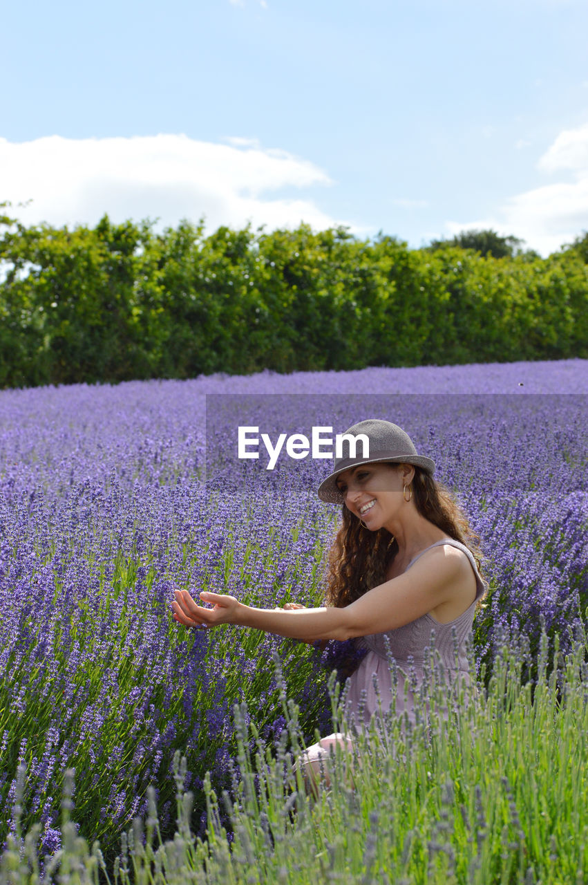 Woman amidst lavenders on field