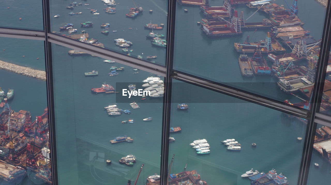 HIGH ANGLE VIEW OF SWIMMING POOL IN BUILDING SEEN THROUGH GLASS