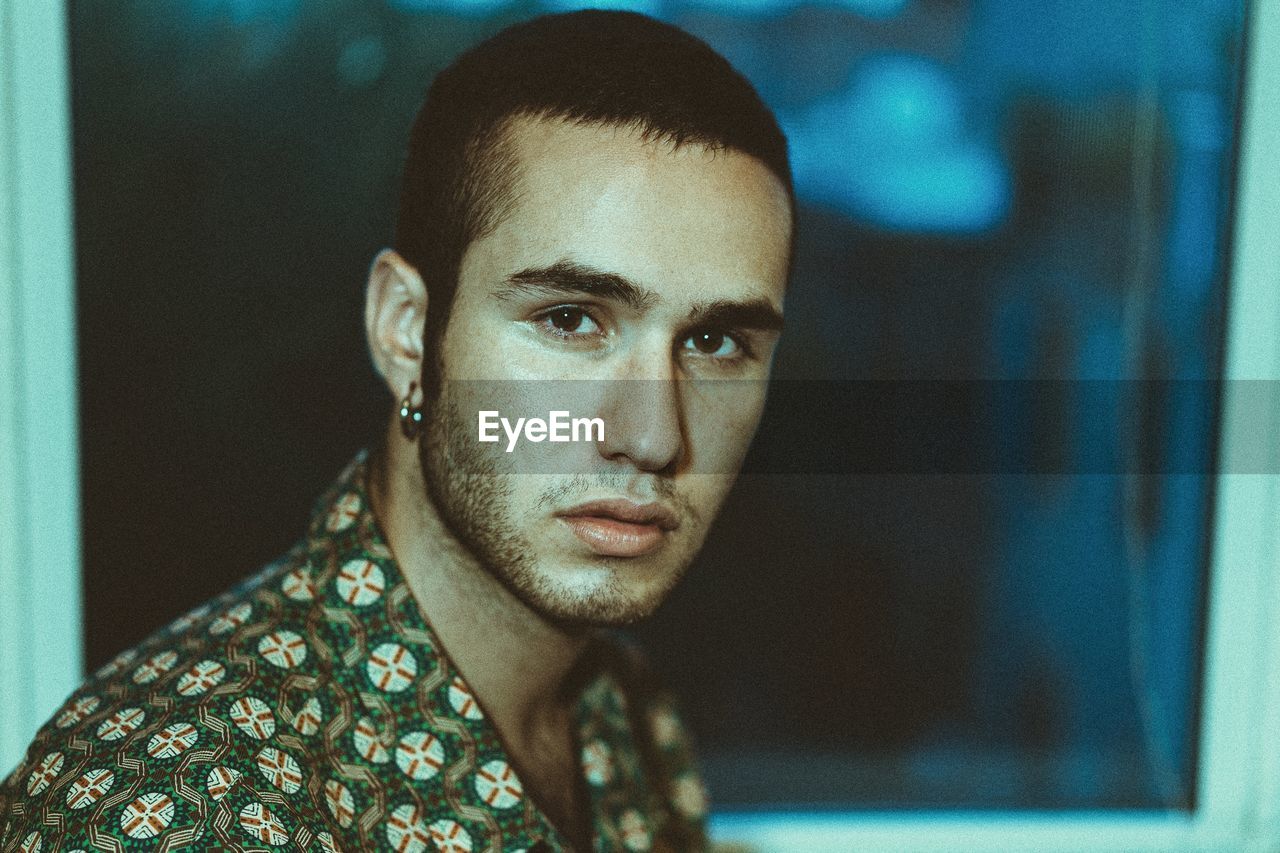 Close-up portrait of young man at home