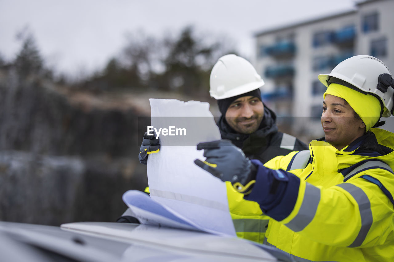 Construction engineers discussing project at construction site