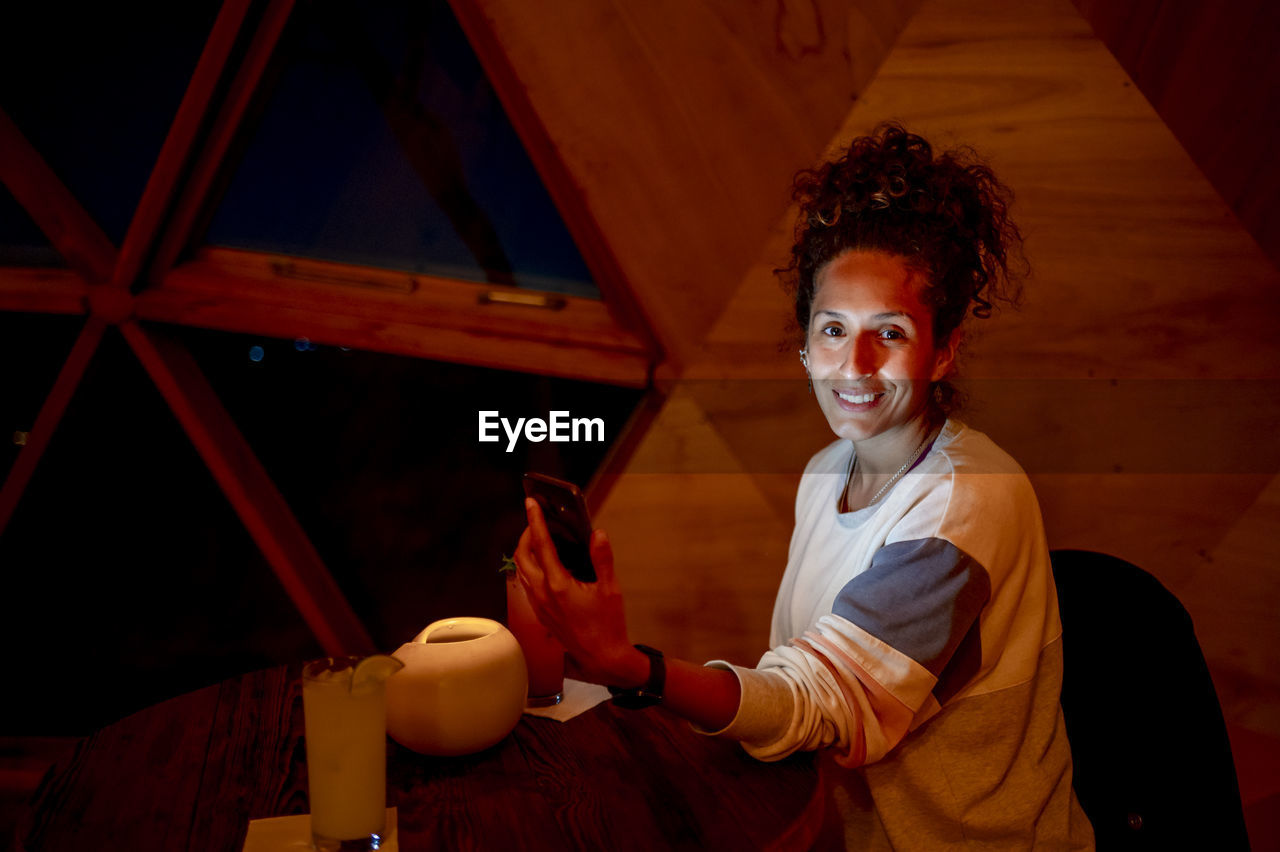 Relaxed woman inside a dome tent.