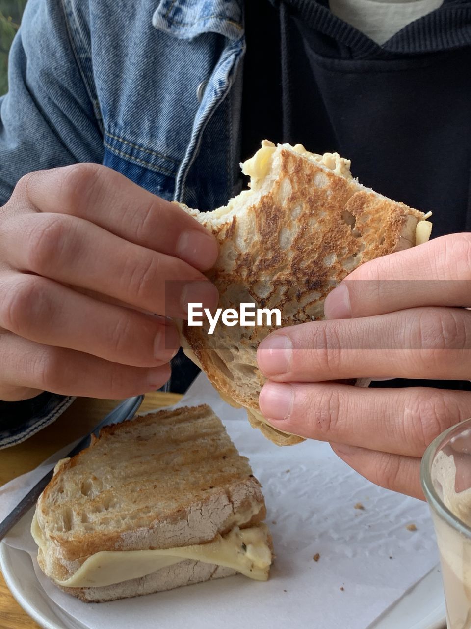 hand, food and drink, food, holding, one person, bread, lifestyles, dish, freshness, adult, fast food, baked, indoors, close-up, women, high angle view, personal perspective, leisure activity, finger, meal