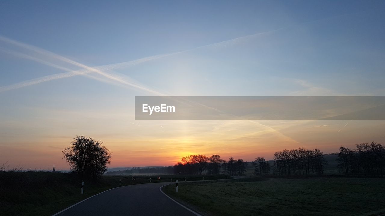 ROAD AGAINST SKY AT SUNSET