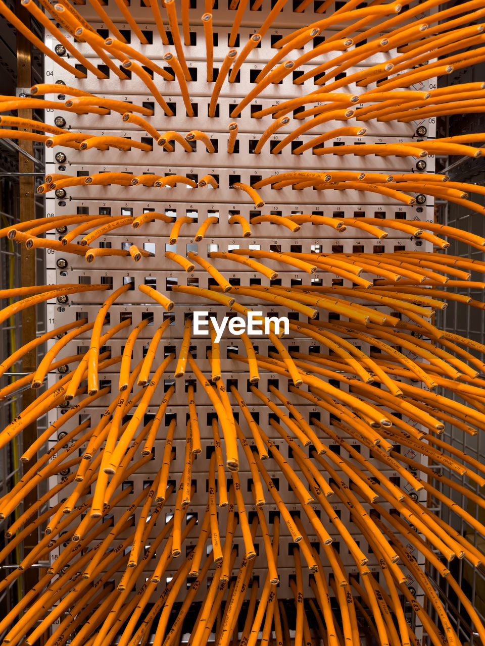 Orange cables in a rack ready for wiring.