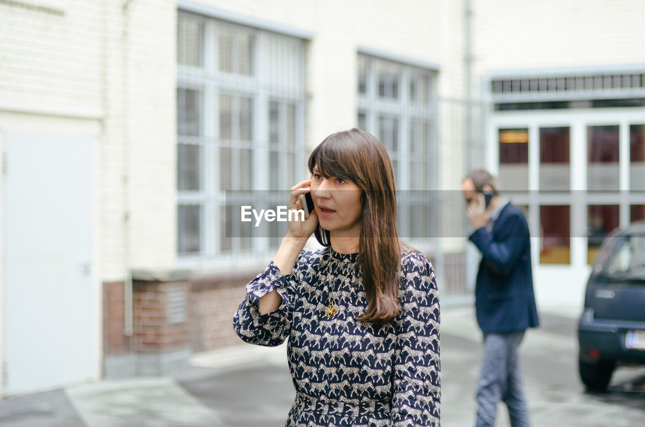 Professional woman using mobile phone in city