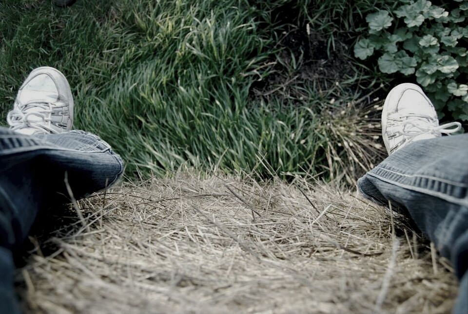 Low section view of man legs on dry grass