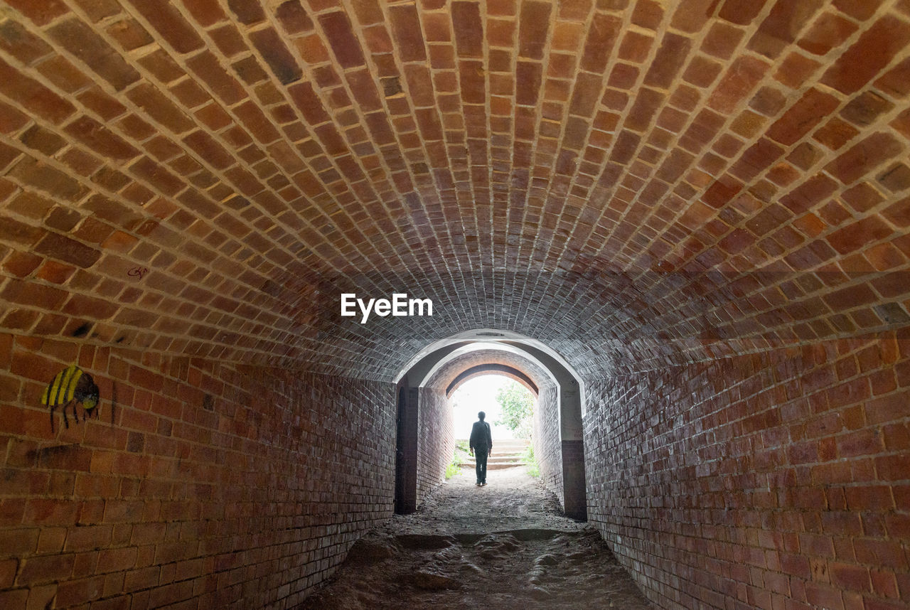 Man walking in tunnel