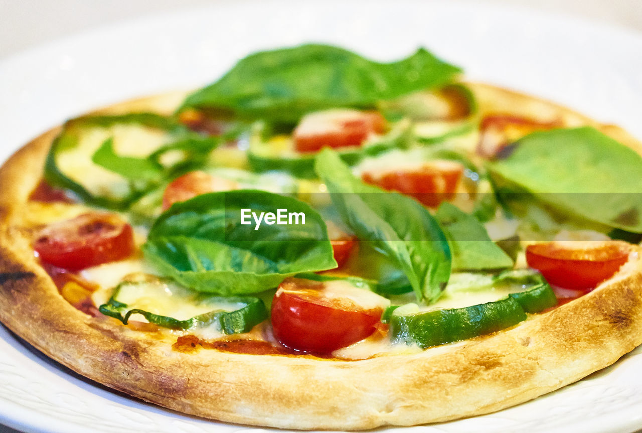 CLOSE-UP OF PIZZA WITH STRAWBERRIES IN PLATE