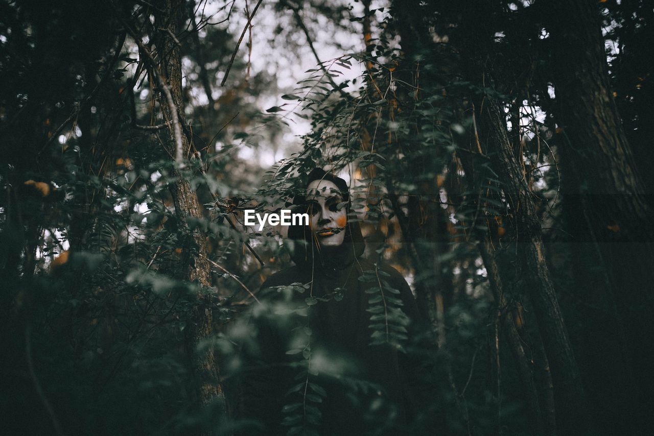 Woman standing in forest