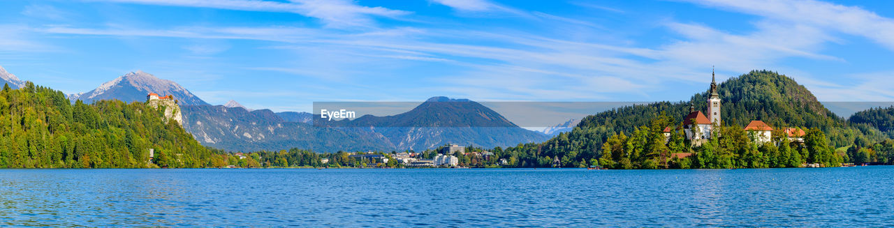 PANORAMIC VIEW OF TREES AND MOUNTAIN AGAINST SKY