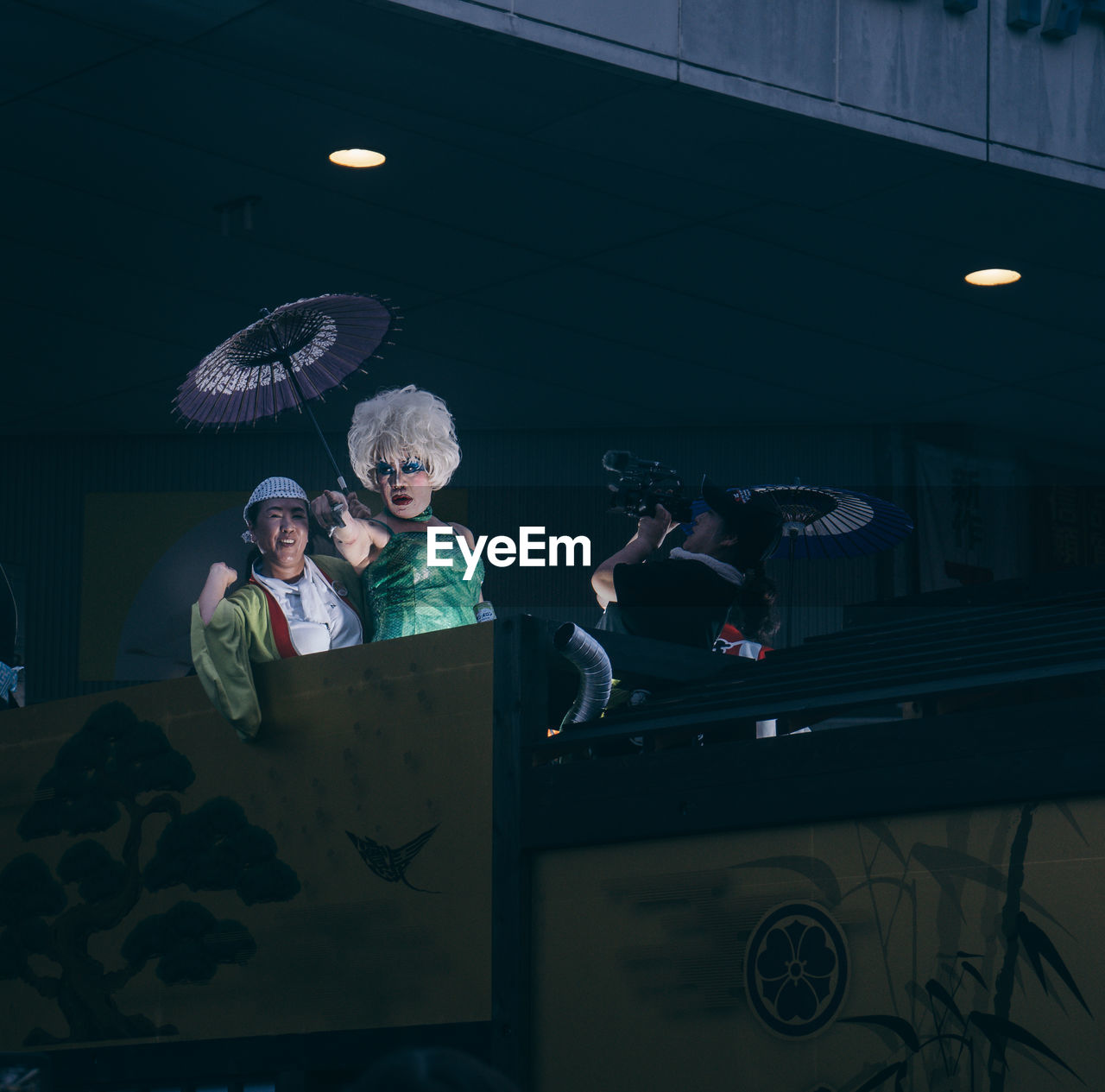 GROUP OF PEOPLE IN ILLUMINATED UNDERGROUND