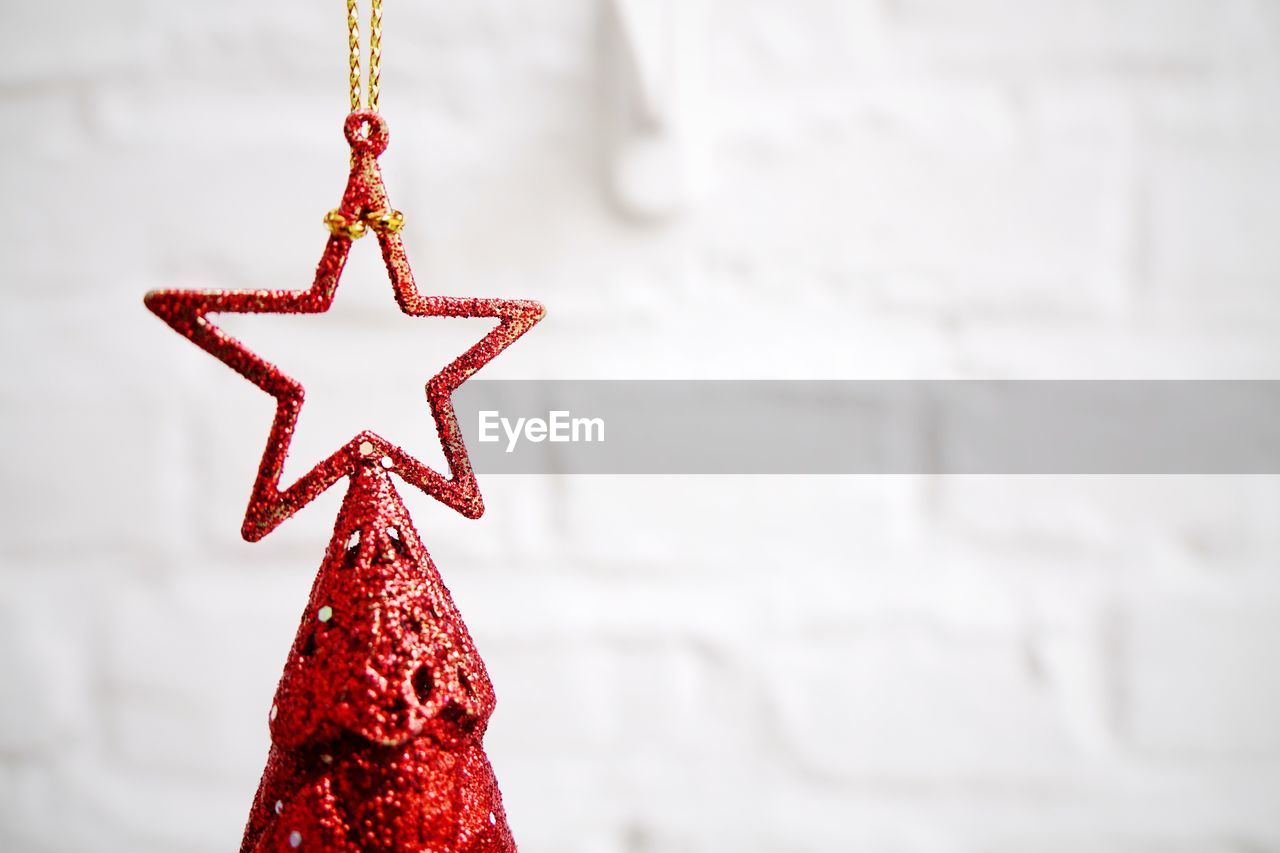 Close-up of tree topper against wall at home