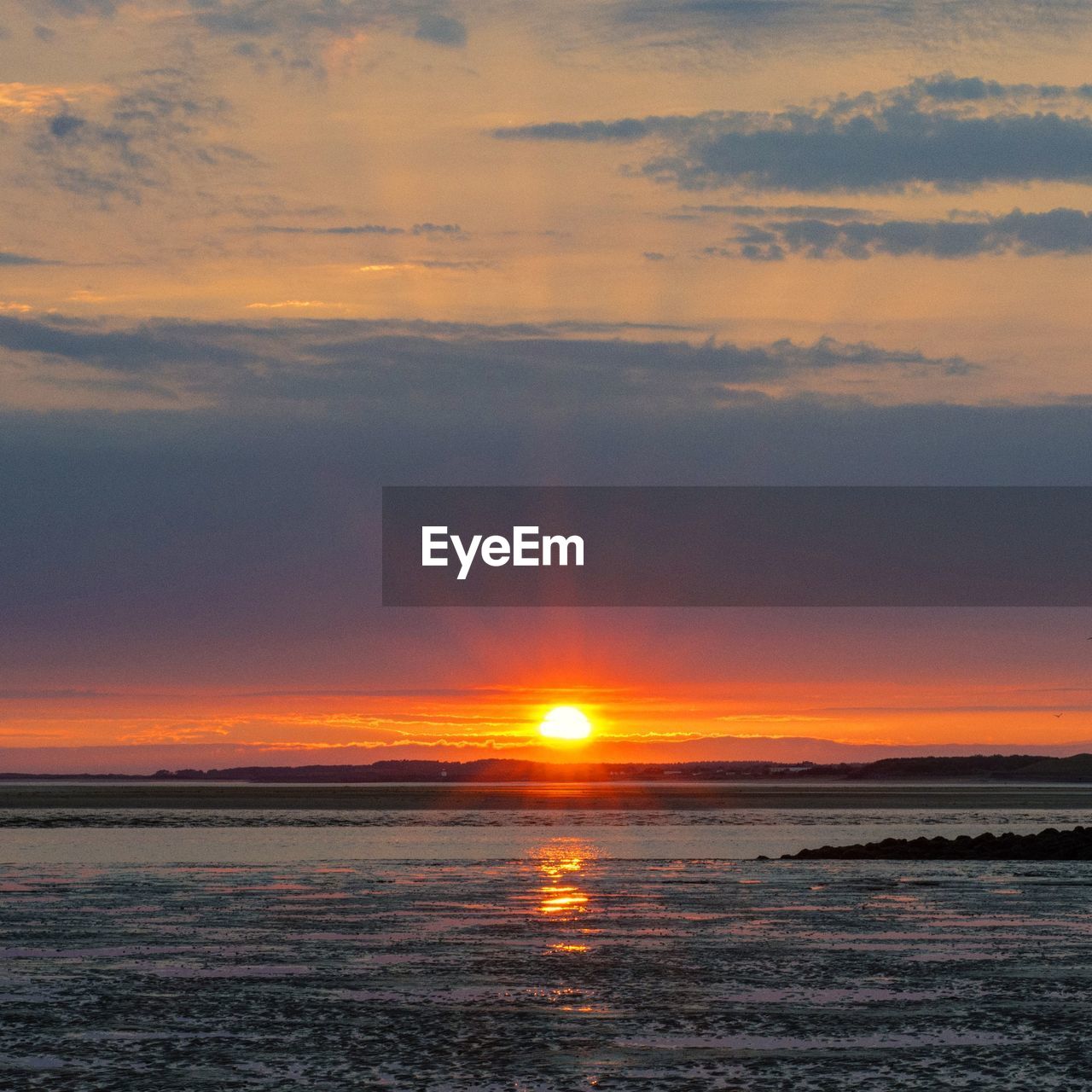 Scenic view of llanelli beach at sunset