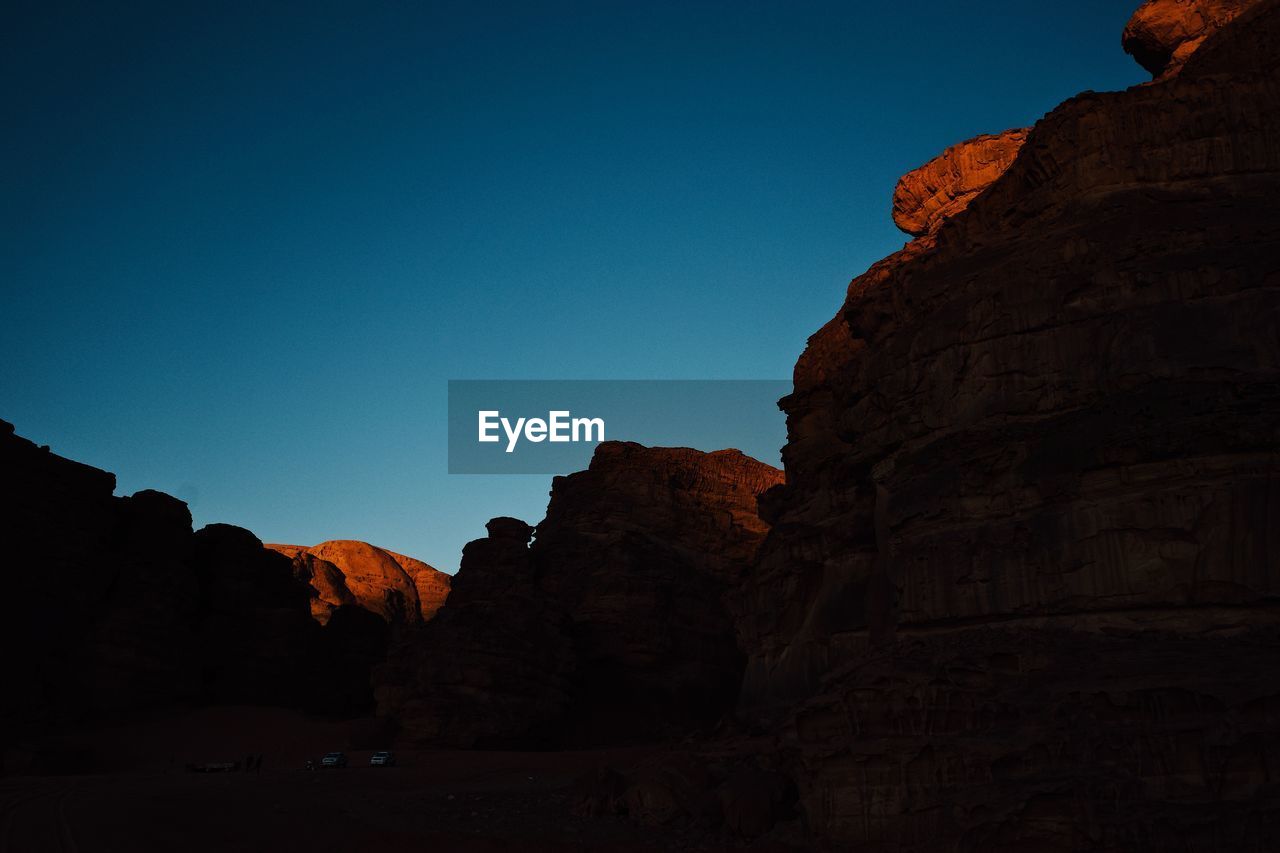 Low angle view of rock formations against blue sky