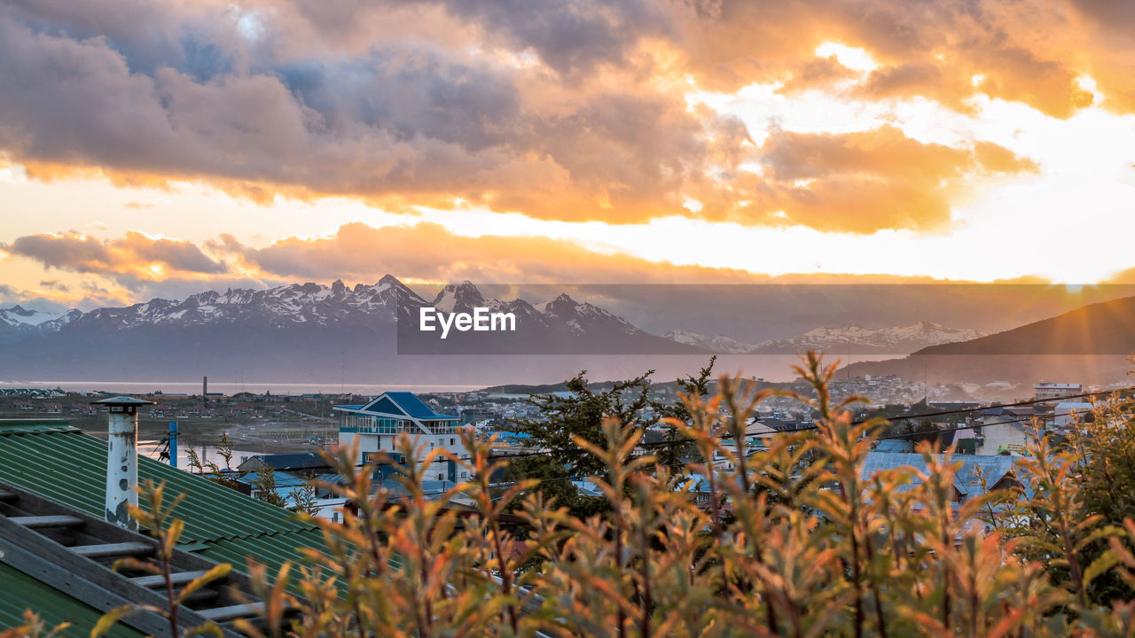 Scenic view of sea and mountains against sky during sunset