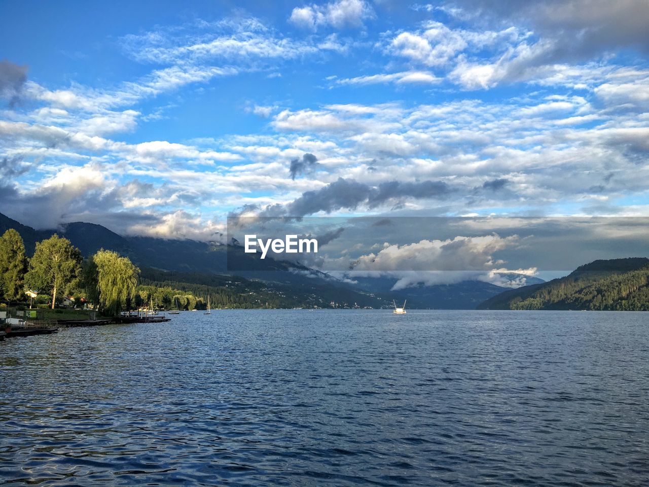 Scenic view of lake and mountains against sky