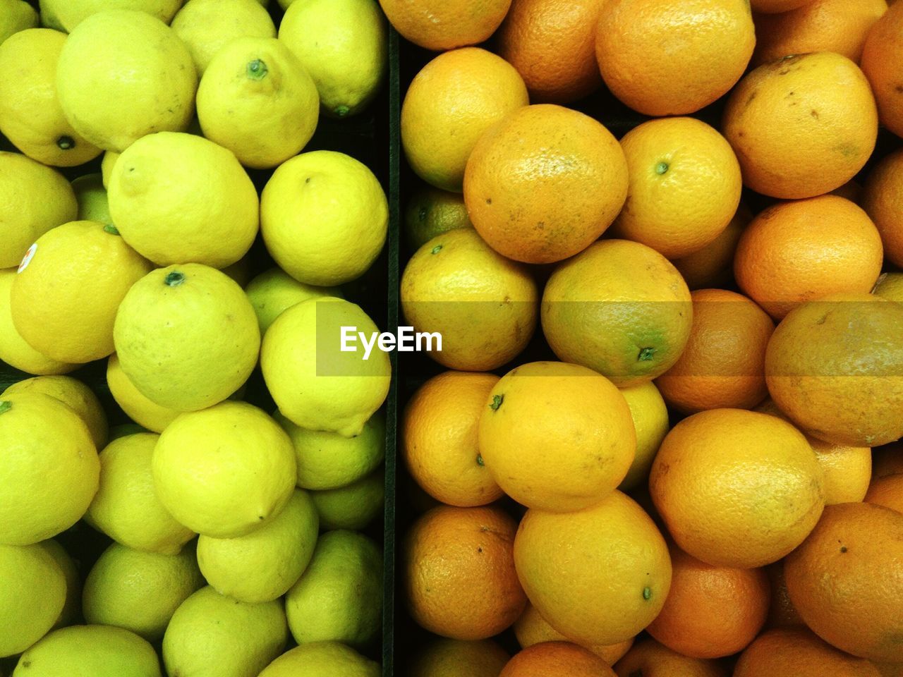 Full frame shot of oranges and lemons for sale at market stall