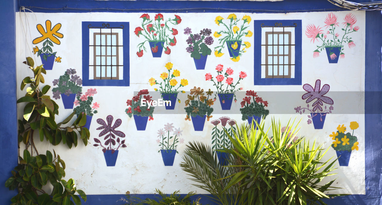 Potted plants against wall