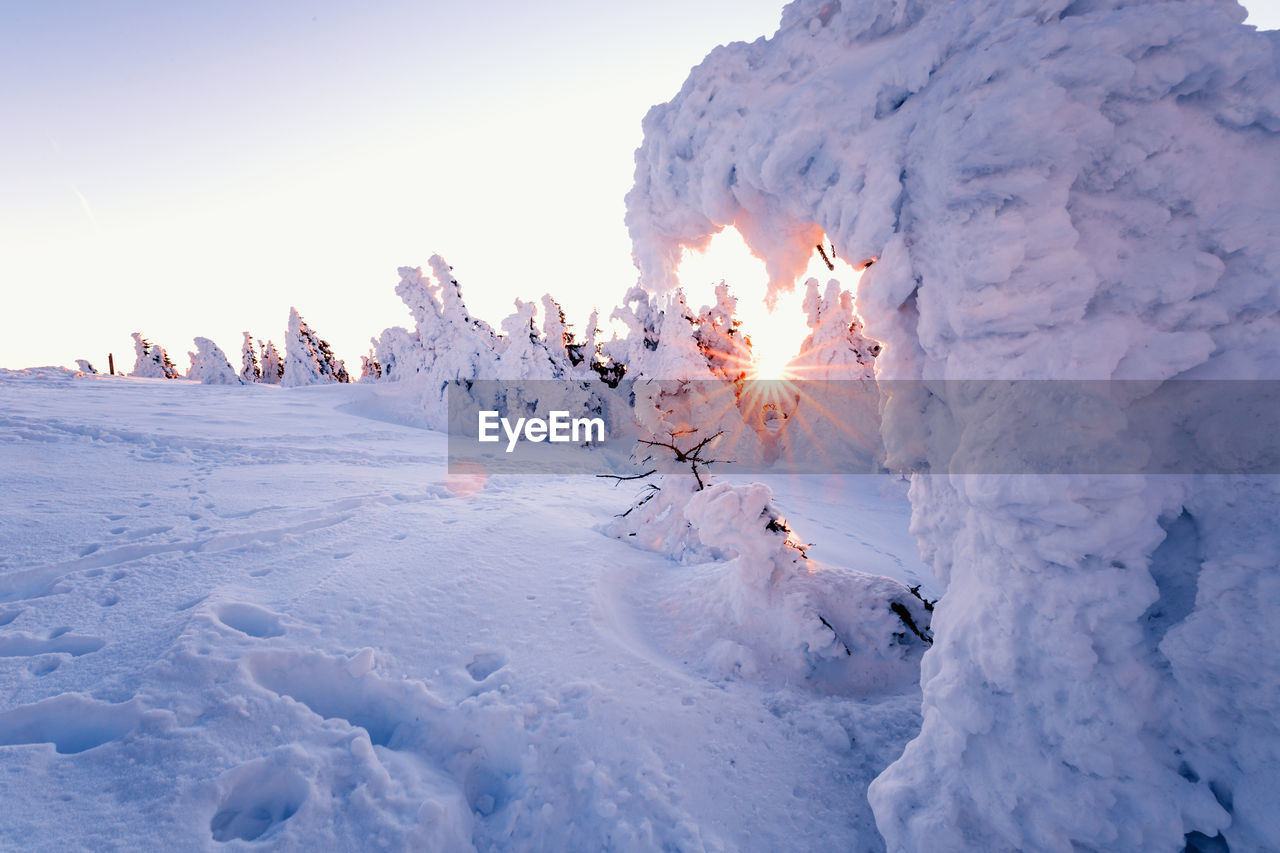 Scenic view of snow covered landscape against sky