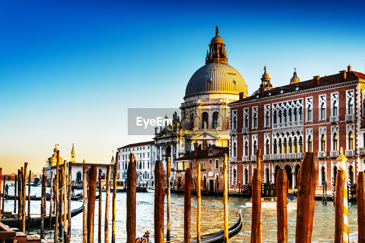 Santa maria della salute by grand canal against clear sky during sunset