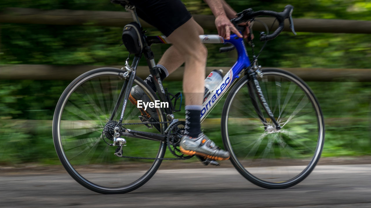 Low section of man riding bicycle