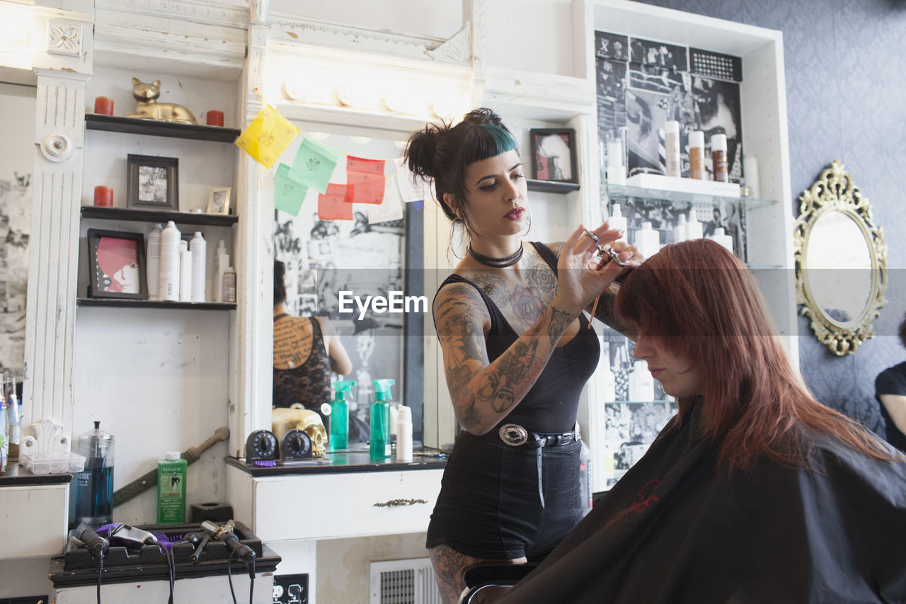 A hair dresser styling a customer's hair.